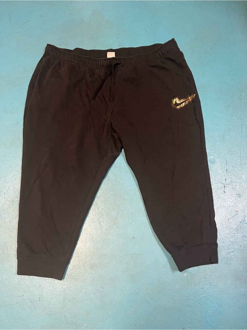 Plus-size Black Nike Sweatpants with gold swoosh